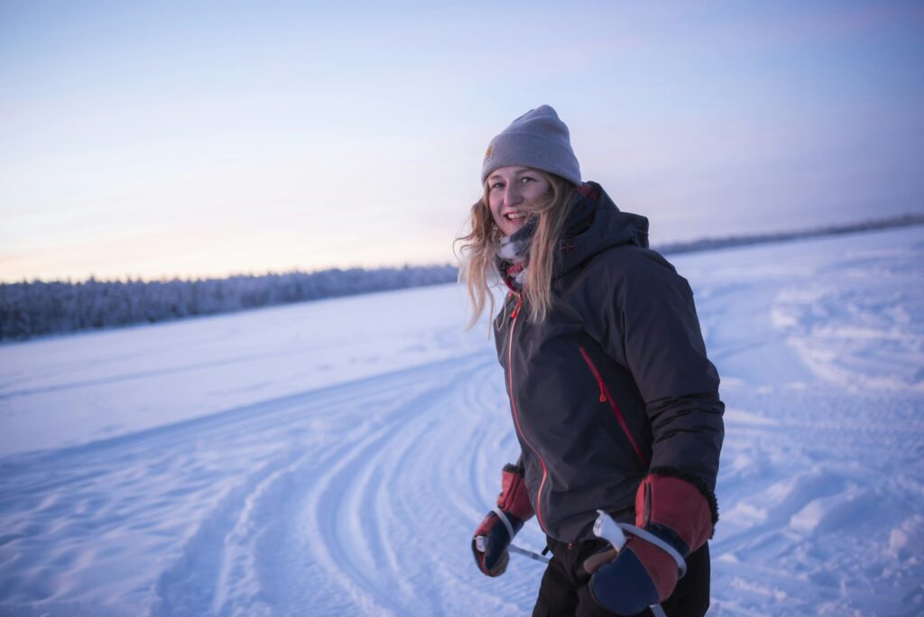 Skiing on the frozen lake at Torassieppi at sunset, Lapland, Finland